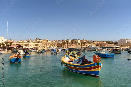 Traditional Maltese boats in the harbor of Marsaxlokk , Malta