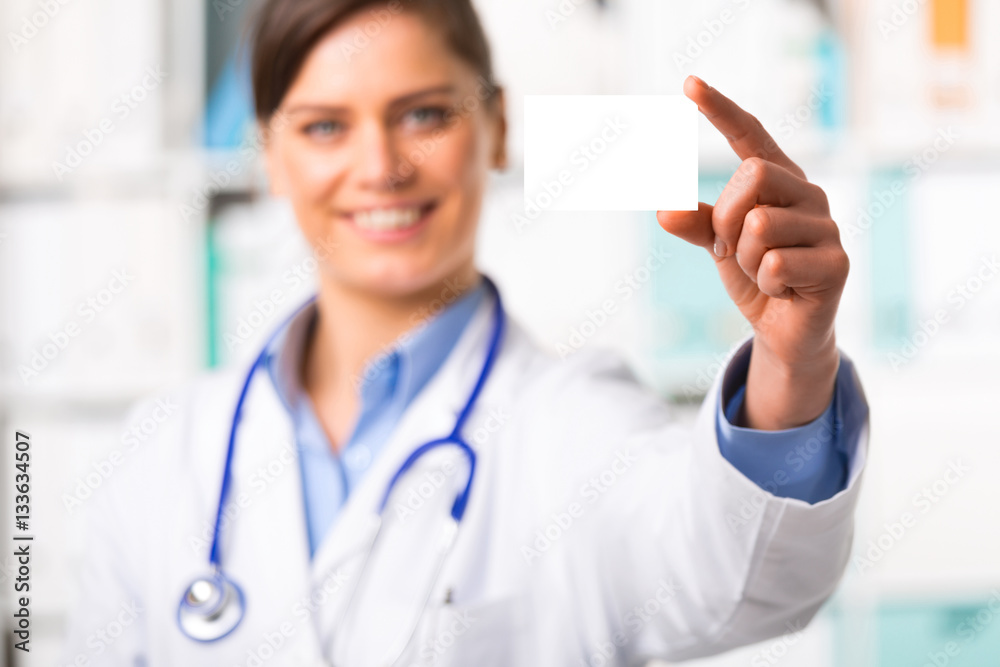 Young female doctor with blank business card Young female doctor with blank business card