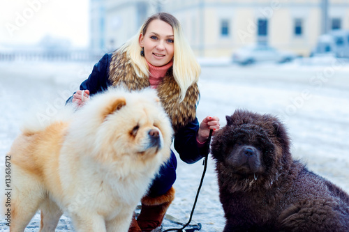 girl in a winter park with a Chow Chow