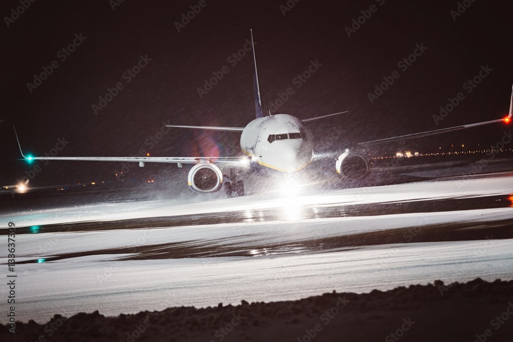 Naklejka premium Passenger airplane takes off during heavy snow