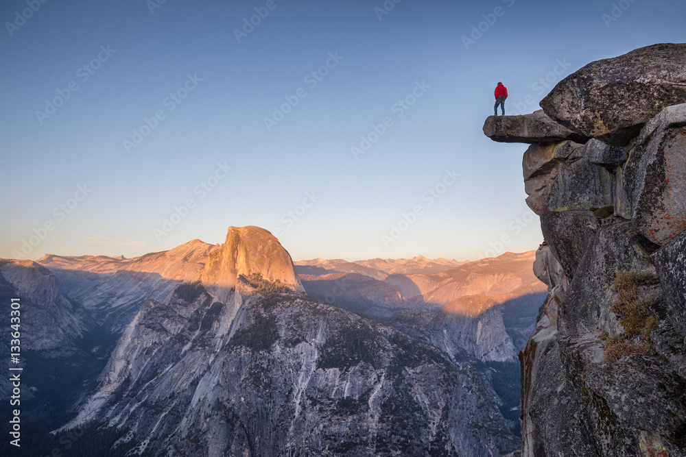 Hiker at Glacier Point at sunset, Yosemite National Park, California, USA