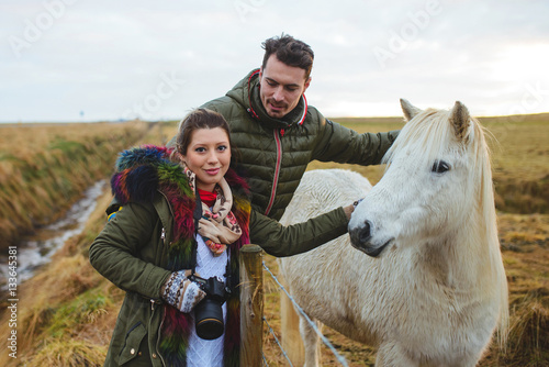 Couple and White Iceland Horse