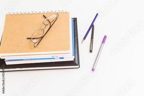 Wallpaper Mural Glasses on notebooks with pen and pencil on white background Torontodigital.ca