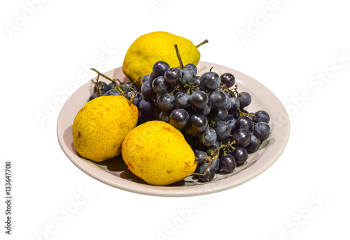 Yellow pear and grapes on the plate