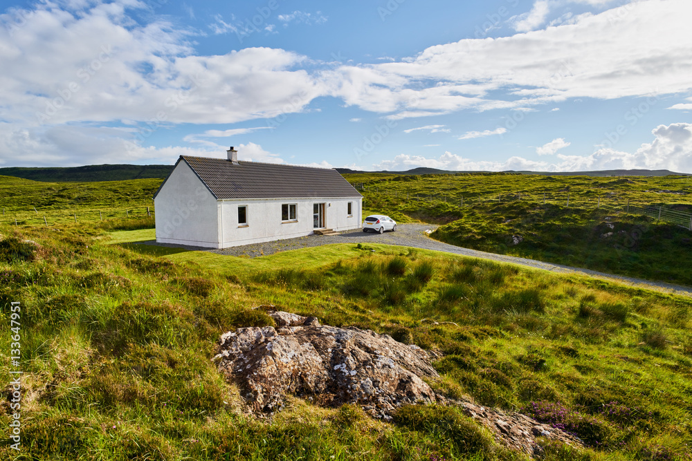 A remote white painted house near Dunvegan on the Isle of Skye, Scotland, UK.      