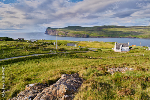 White painted houses of Milovaig overlooking Loch Pooltiel near Dunvegan on the Isle of Skye, Scotland, UK.       photo