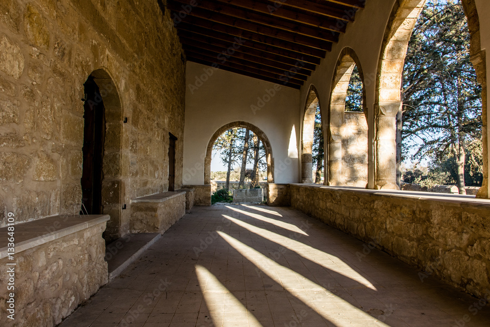 Old church monastery with sun shining into loggia 