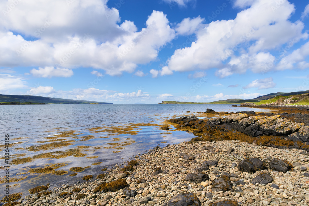 Sea views on a sunny day from a pebble beach at Uiginish Point near Dunvegan on the Isle of Skye, Scotland, UK.      