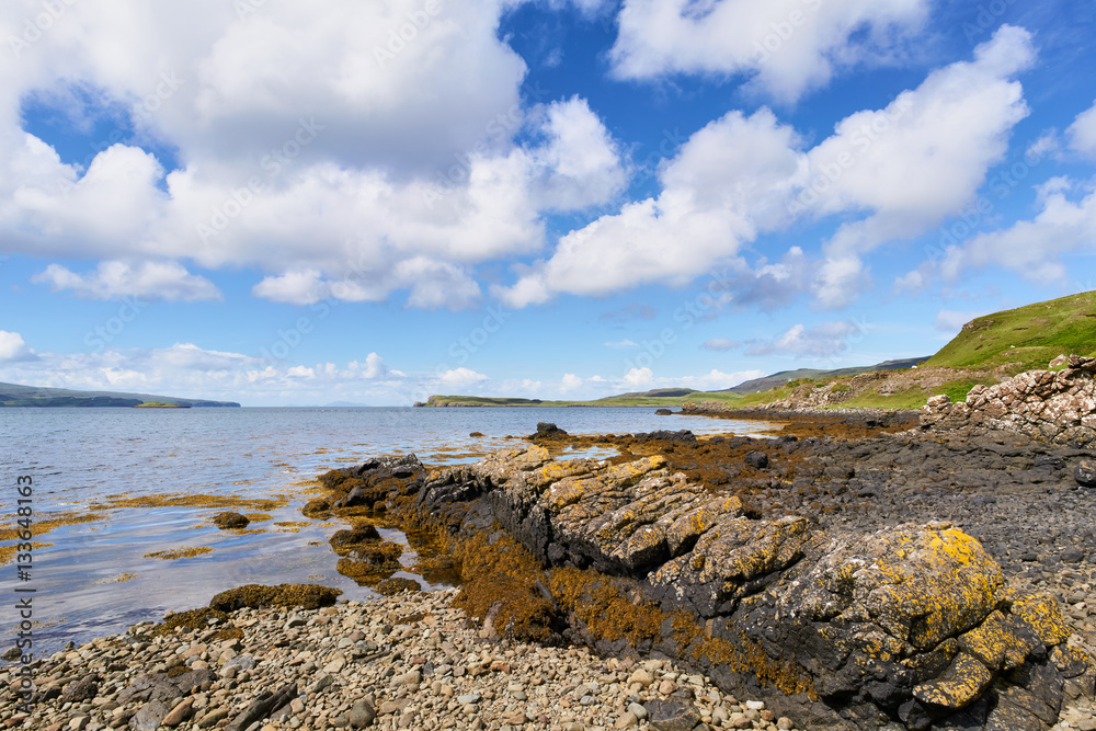 Sea views on a sunny day from a pebble beach at Uiginish Point near Dunvegan on the Isle of Skye, Scotland, UK.      