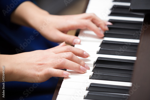 Closeup of hands playing piano. Music and hobby concept