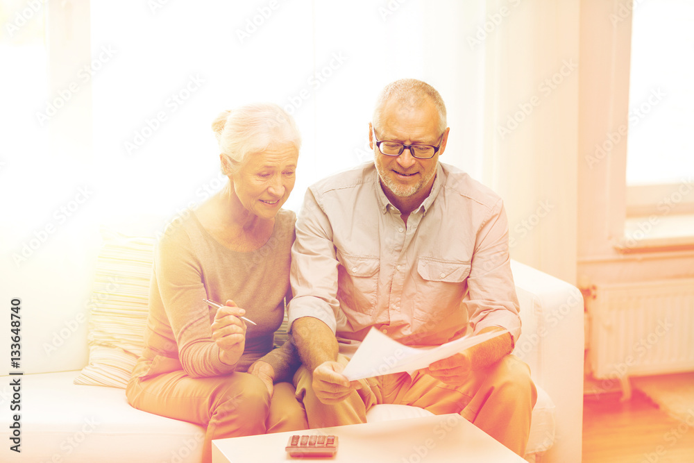 senior couple with papers and calculator at home senior couple with papers and calculator at home