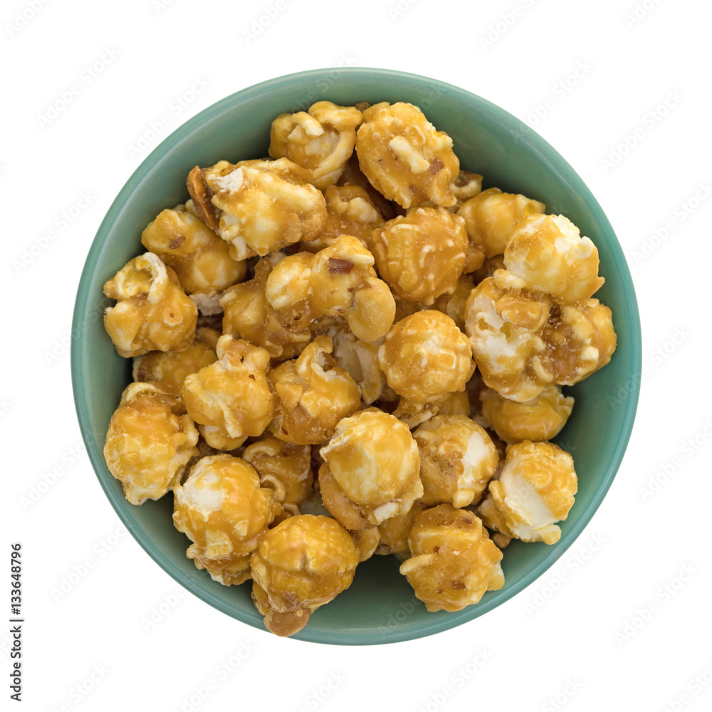 Toffee caramel popcorn in a green bowl isolated on a white background. Toffee caramel popcorn in a green bowl isolated on a white background.