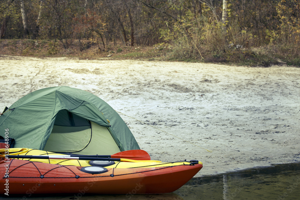 Fototapeta premium Camping with kayaks on the river bank.