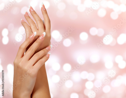 Beautiful woman hands against an abstract background