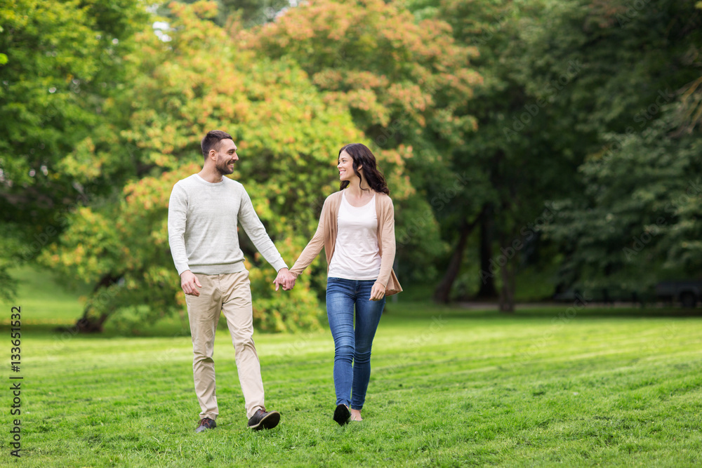 happy couple walking in summer park happy couple walking in summer park