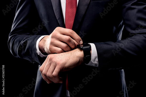 Businessman checking smartwatch