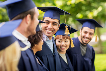 happy students or bachelors in mortar boards