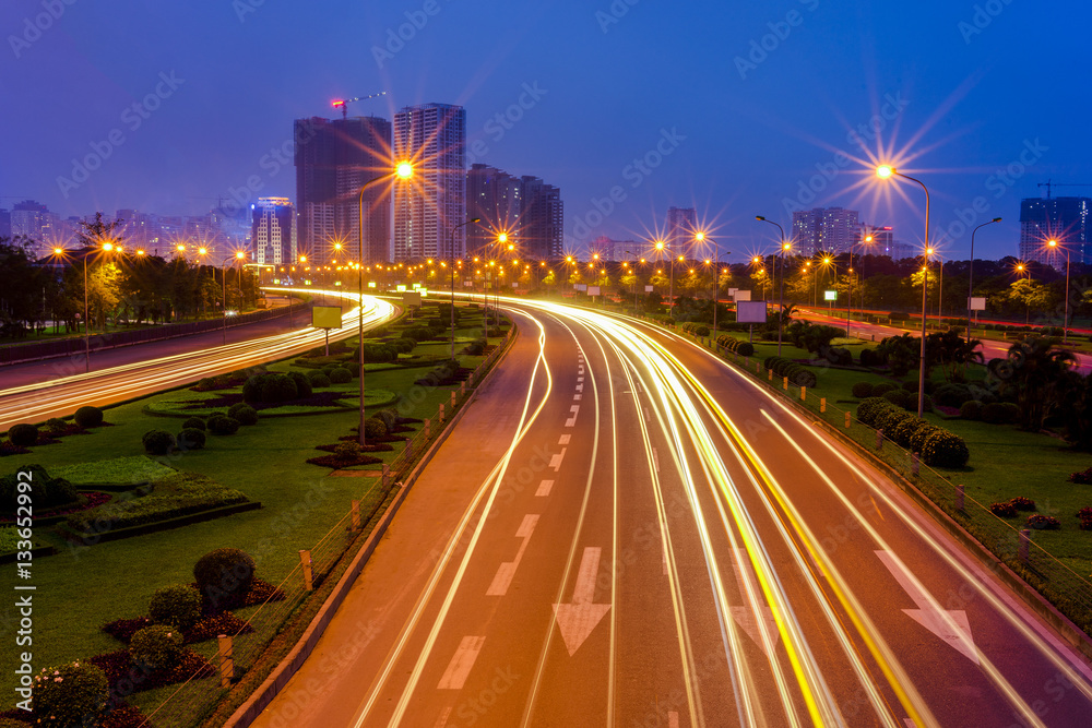 Hanoi cityscape at Thang Long multiple land highway at night. Focus on the highway
