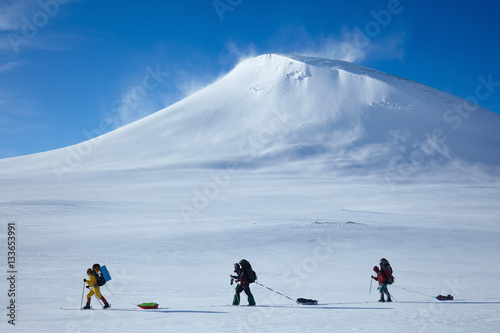 Ski touring group with backpacks and sleds (pulkas)