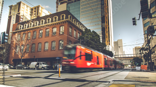 Fényképezés Red trolley through the building in downtown San Diego, USA