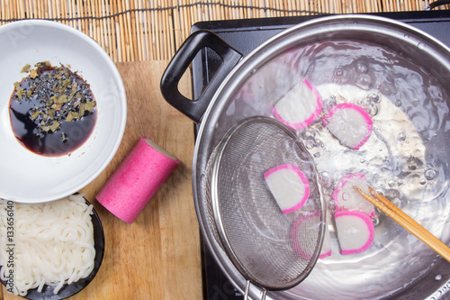 Chef boiling kamaboko (fish cake) in pot