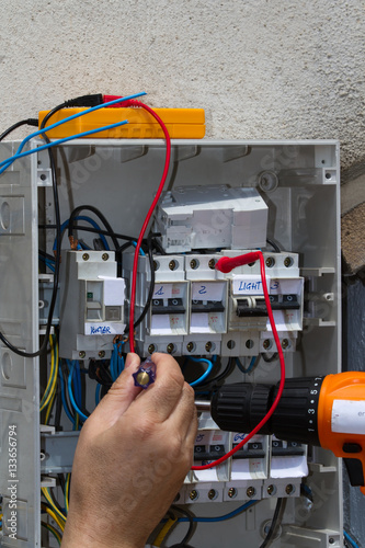 electrician at work with an electric panel