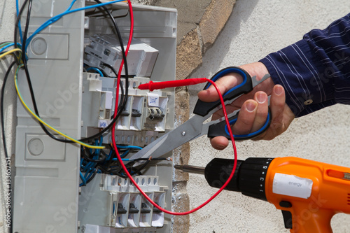 electrician at work with an electric panel