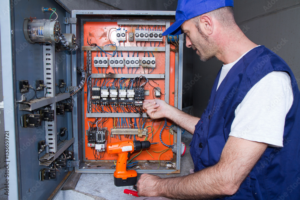 electrician at work with an electric panel