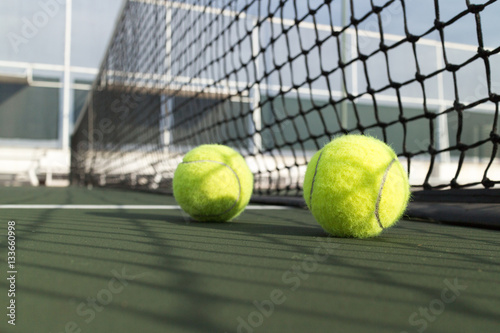 Tennis ball on green tennis hard court © icedmocha