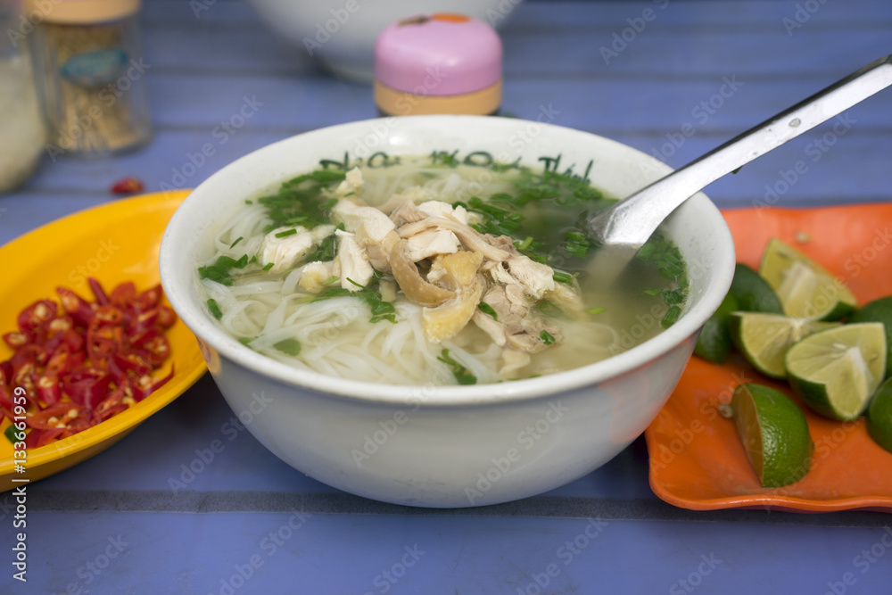 Vietnamese chicken noodle soup called pho, with green onion, bean sprouts and chili Vietnamese chicken noodle soup called pho, with green onion, bean sprouts and chili