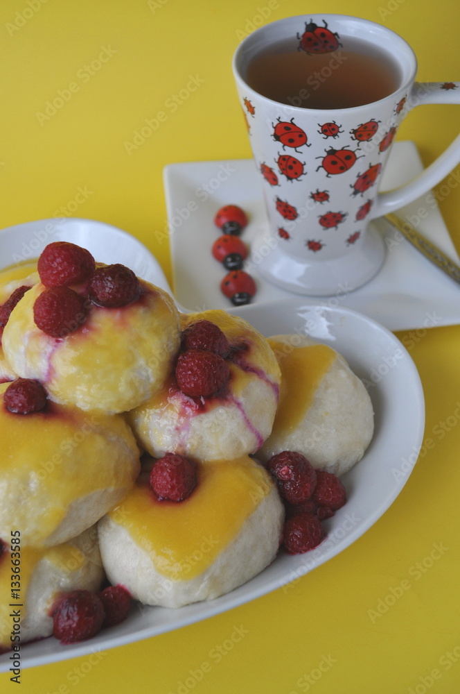 Nicely served Central European dessert of sweet steamed dumplings (an alternative version of Austrian Germknoedel) with hot fruit sauce on a colorful background
Nicely served Central European dessert of sweet steamed dumplings (an alternative version of Austrian Germknoedel) with hot fruit sauce on a colorful background