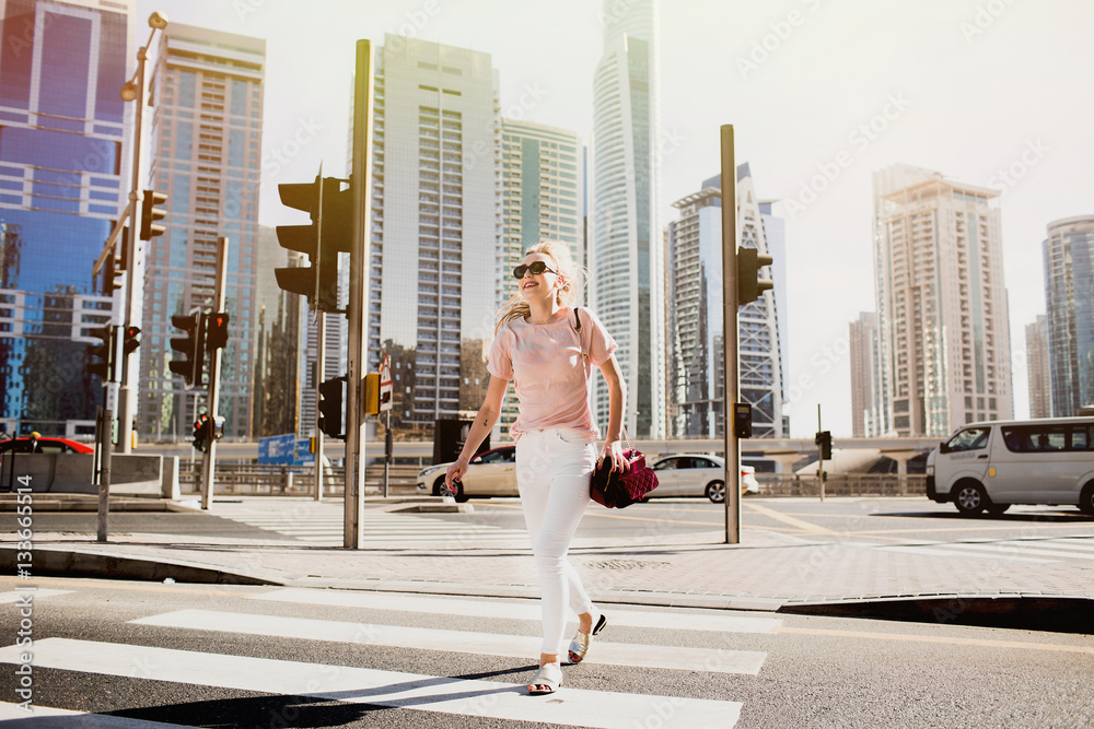 Funny girl runs on crossing somewhere in Dubai Funny girl runs on crossing somewhere in Dubai