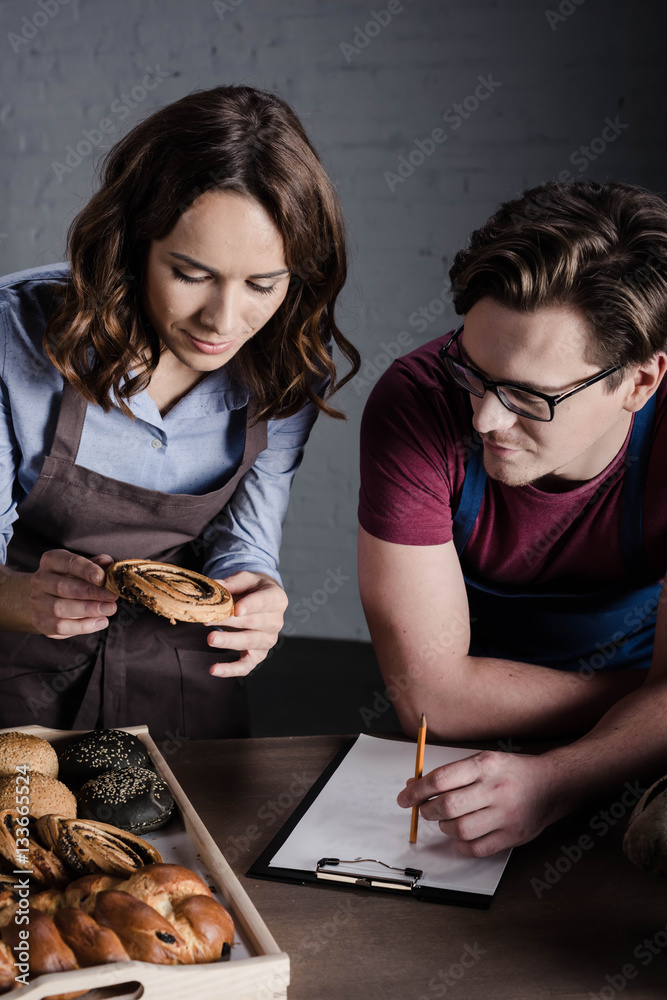 Bakers examining pastries Bakers examining pastries