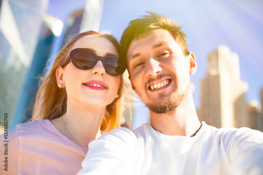 Cheerful young couple enjoys sun before skyscrapers in Dubai Cheerful young couple enjoys sun before skyscrapers in Dubai