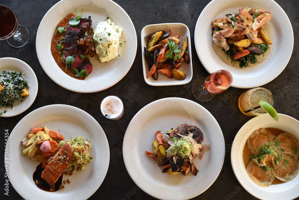 Variety of freshly prepared dishes on table, overhead view Variety of freshly prepared dishes on table, overhead view
