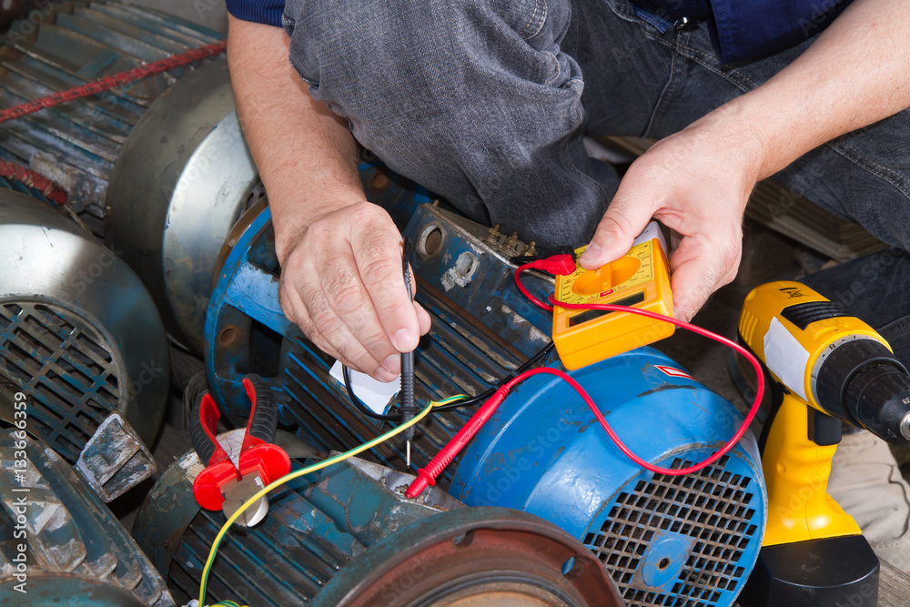 repairman during maintenance work of electric motors