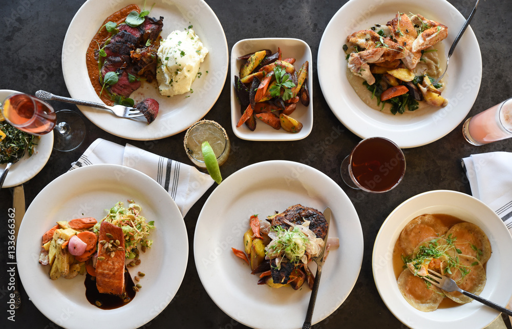 Variety of freshly prepared dishes on table, overhead view Variety of freshly prepared dishes on table, overhead view