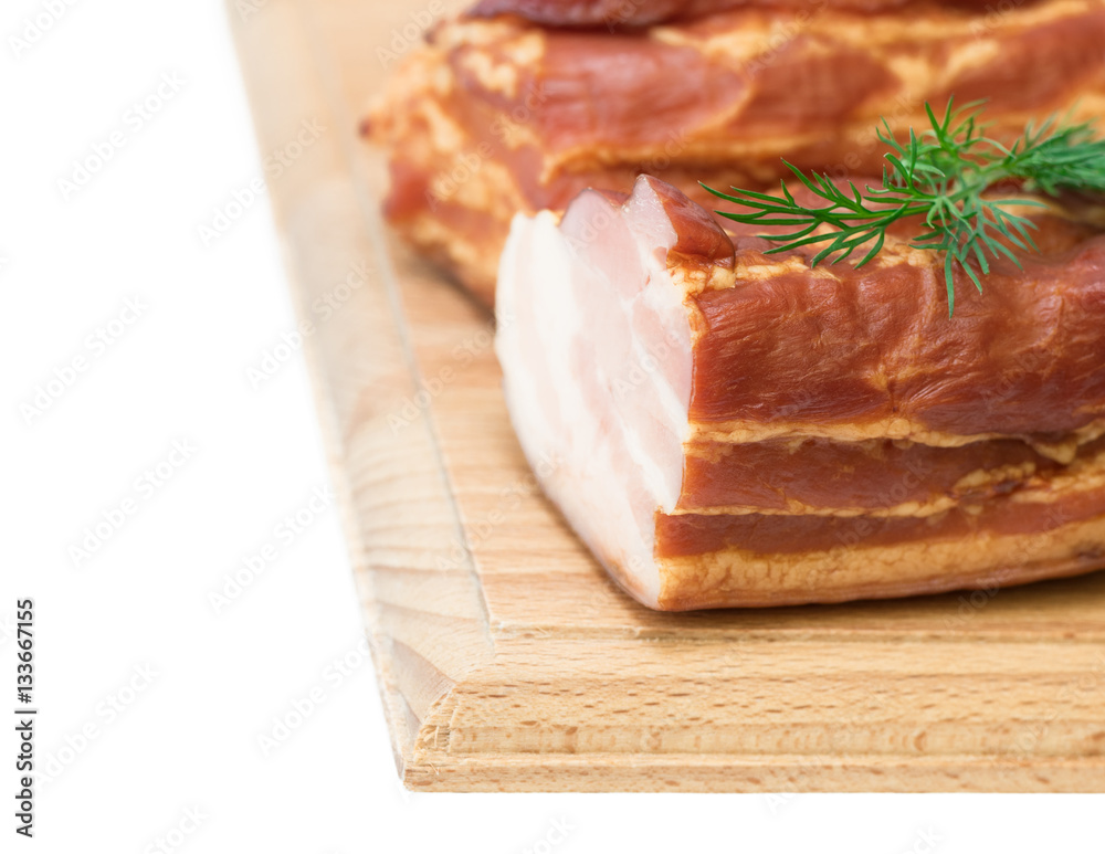 Smoked pork with spices on a wooden board isolated on white background.