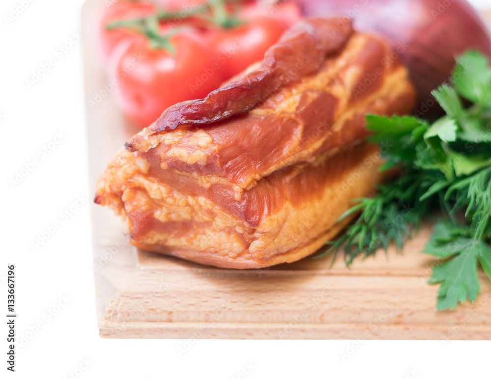 Smoked pork with spices on a wooden board isolated on white background. Smoked pork with spices on a wooden board isolated on white background.