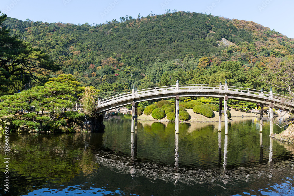 Japanese Ritsurin Garden and wooden bridge