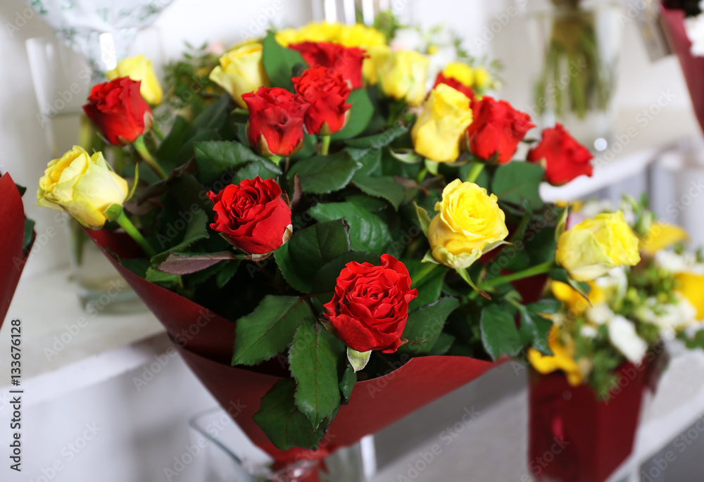 Beautiful bouquet of red and yellow roses at floral shop, closeup Beautiful bouquet of red and yellow roses at floral shop, closeup