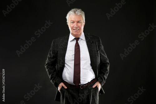 Senior businessman on black...
