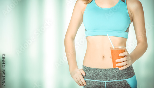 Young woman drinking fresh healthy smoothie after workout. Fitness and healthy lifestyle concept. photo