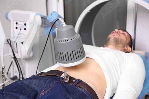 Inductive shortwave diathermy for young man in modern clinic