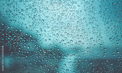 Water droplets on a glass blurry background in vintage style.