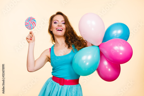 Woman with colorful balloons and lollipop © Voyagerix