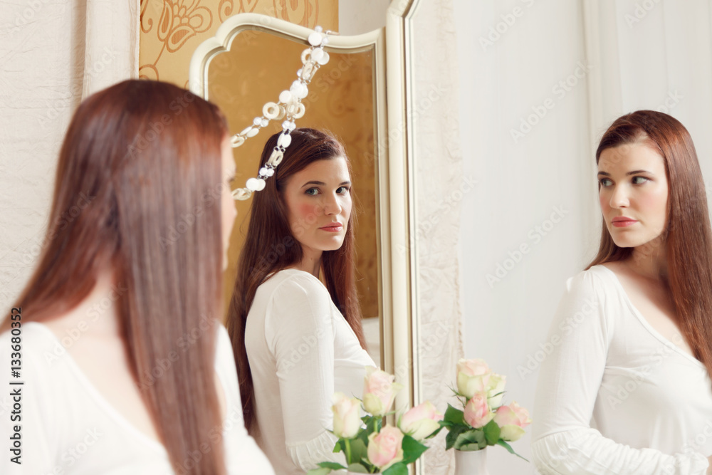 Fototapeta premium Woman looking into mirror