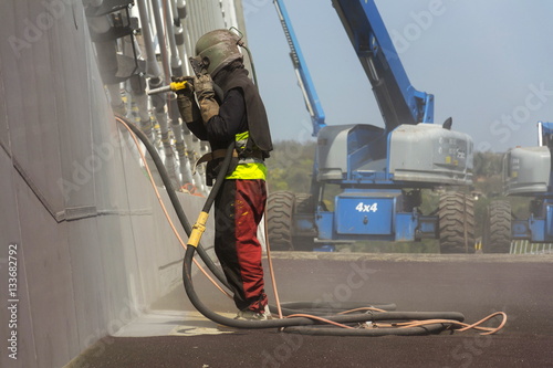 Slika na platnu Man with helmet like robot working on a bridge construction
