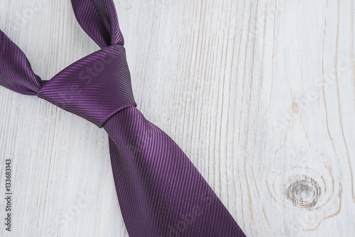 necktie on light wooden background close up photo