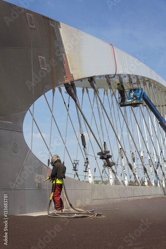 Man with helmet like robot working on a bridge construction